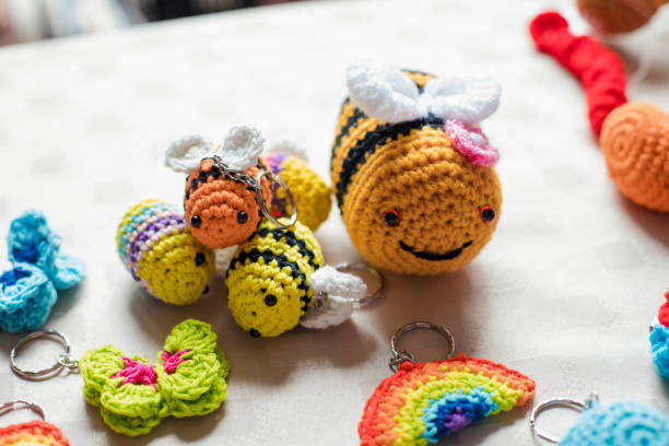 Colorful crocheted bee keychains and charms—perfect beginner projects from a crochet kit.