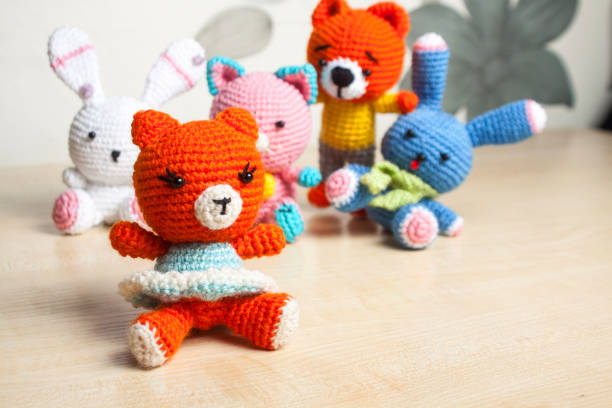 Two friends joyfully crocheting together on floor—showcasing creativity inspired by a crochet kit.
