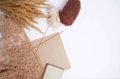 Warm fall crafting scene with yarn, needles, and crochet; perfect for a Crochet Kit.