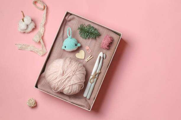 Beautifully arranged crochet kit box with yarn, hooks, and a finished whale toy.