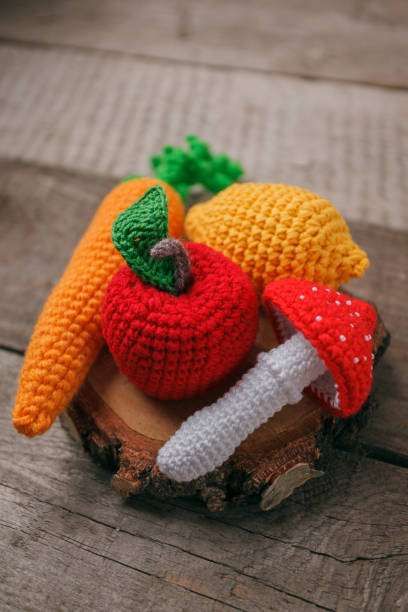 Adorable crocheted apple, carrot, lemon, and mushroom, inspiring a creative Crochet Kit.