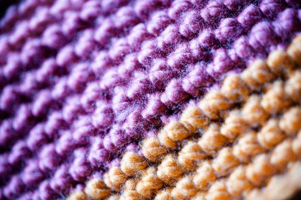 Close-up of vibrant purple and orange crocheted fabric, inspiring a new Crochet Kit project.
