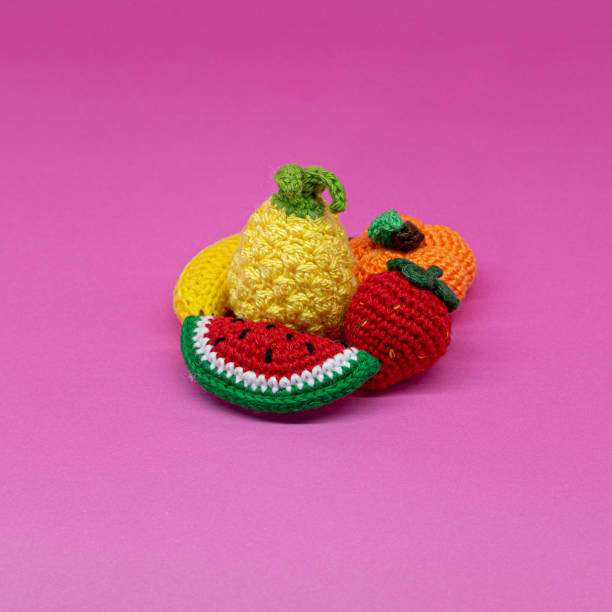 Adorable crocheted fruit, including watermelon and pineapple, perfect for a beginner Crochet Kit.