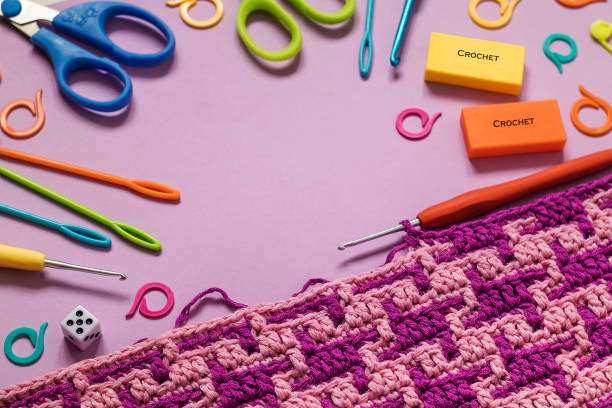 Crochet tools and a patterned project, showcasing items found in a comprehensive Crochet Kit.